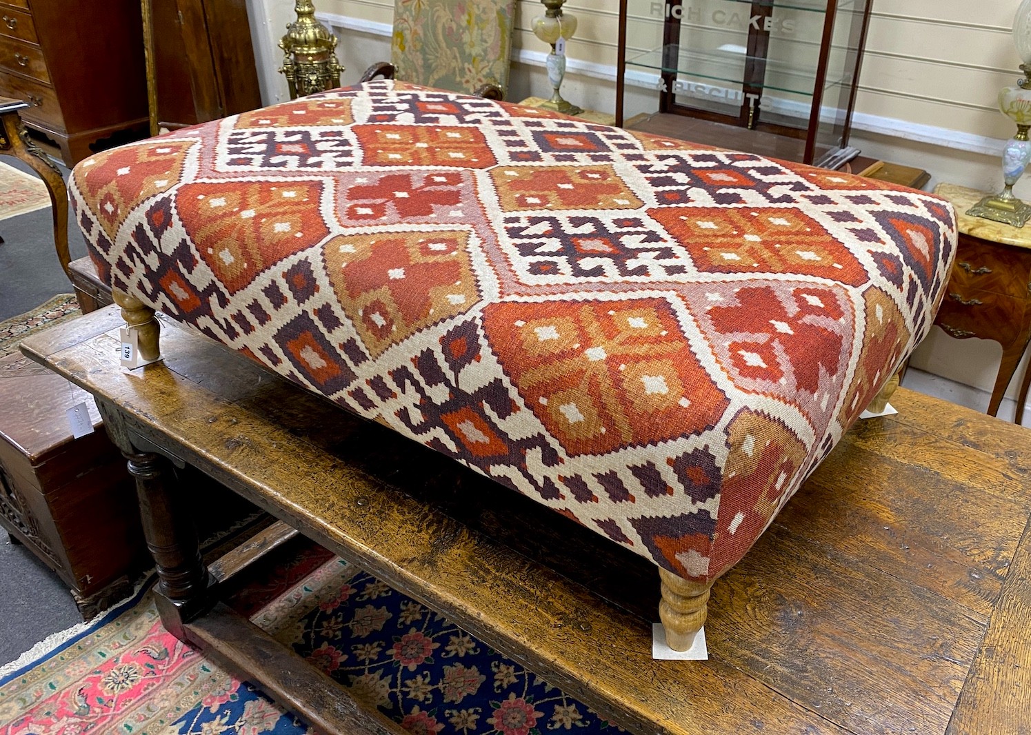 A large contemporary rectangular footstool upholstered in Kilim style fabric on turned beech feet, length 125cm, depth 74cm, height 39cm